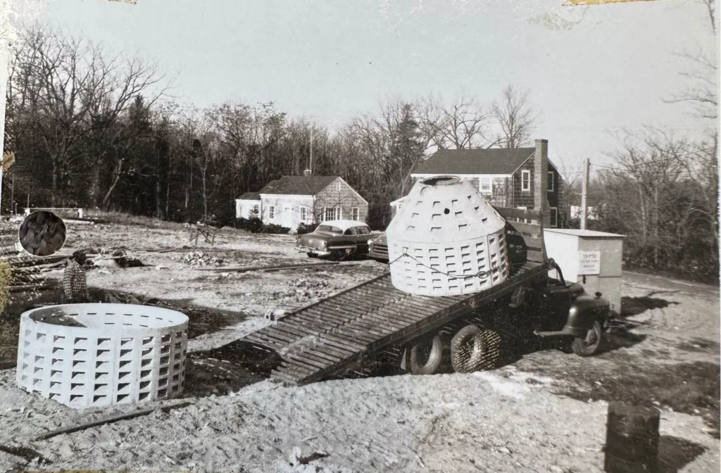 Photo of Carlson truck unloading precast rings, circa 1950s.