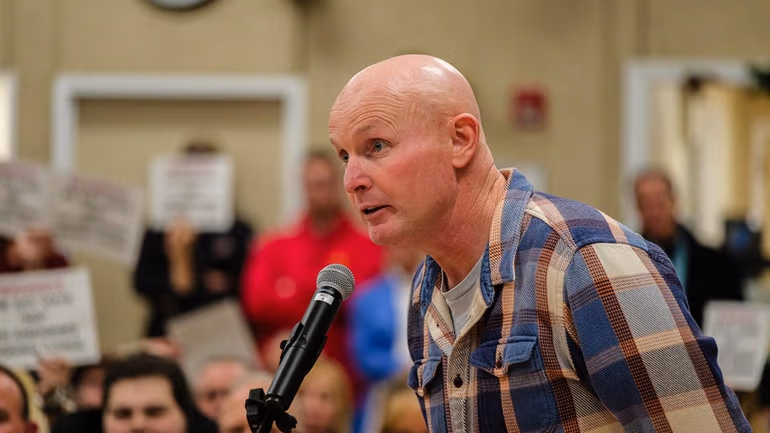 CarlsonCorp owner Toby Carlson defends the project proposal at a public heaing on possible zoning changes in January. Credit: Jeff Bachner